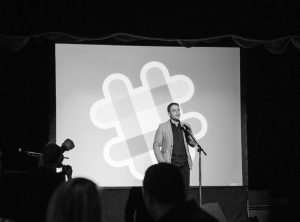 image of a presenter with a large slide behind him, an image of a hashtag