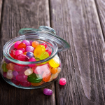 A jar of jelly beans sitting on a table