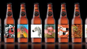 Six bottles of beer in a line with all different labels