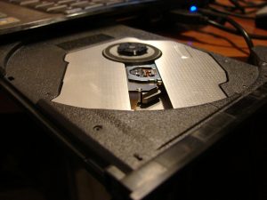 A metal and plastic tray that juts out of a computer.