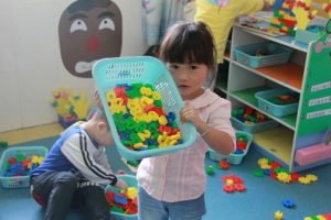 This child might use classification if she sorts these toys by color.