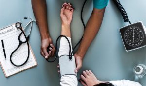A woman having her blood pressure taken