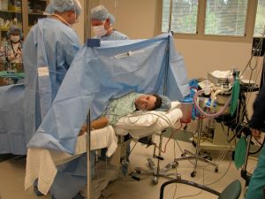 A woman receiving a C-section.