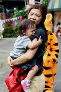This child is seeking comfort from an attachment figure.
