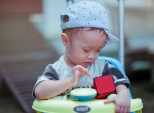 A male infant wearing stereotypically masculine clothing.