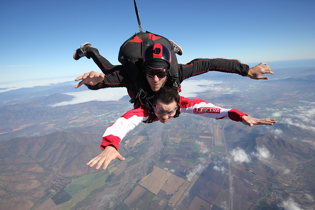 A man tandem skydiving