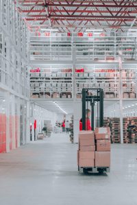 Forklift moving stock inside a warehouse.