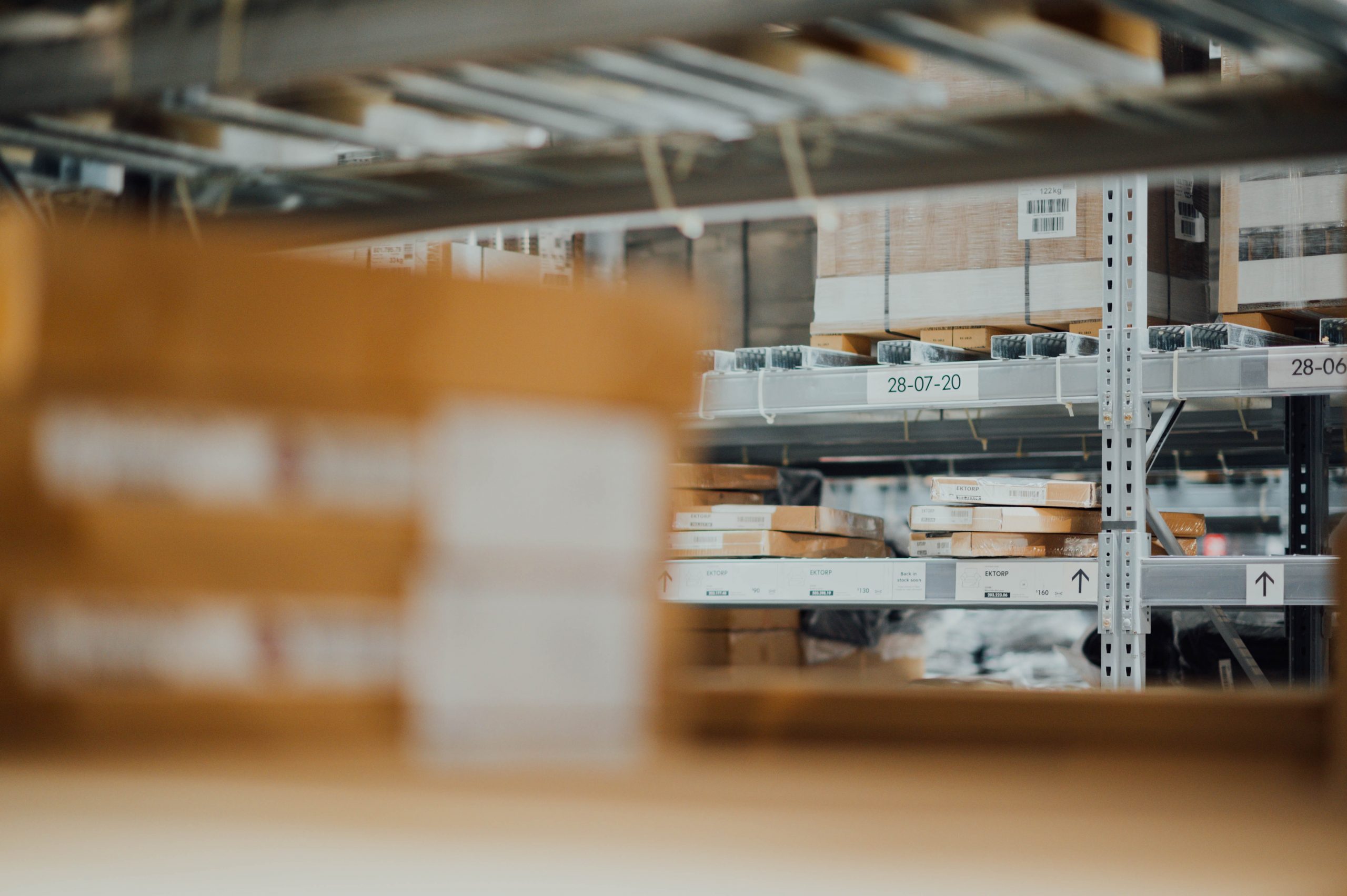 Shallow focus photo of gray steel shelving in a warehouse.