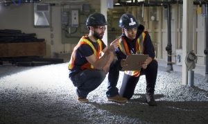 two students on job site wearing safety gear