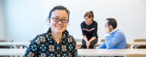 student in classroom ,smiling
