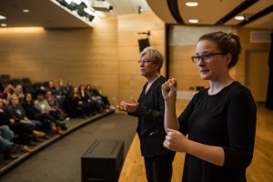 faculty giving lecture to a room of students.