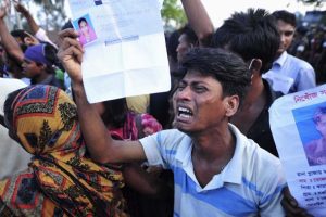 A relative reacts with a picture of a missing garment worker