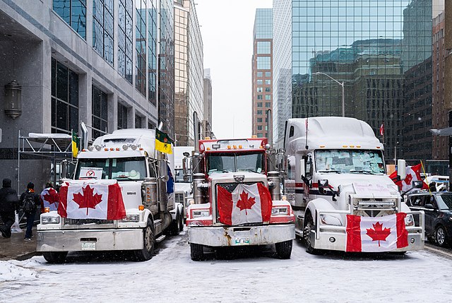 Three trucks draped with Canadian flags at the anti-vaccine protests in Otaawa in 2022