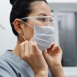 woman wearing protective goggles and a face mask
