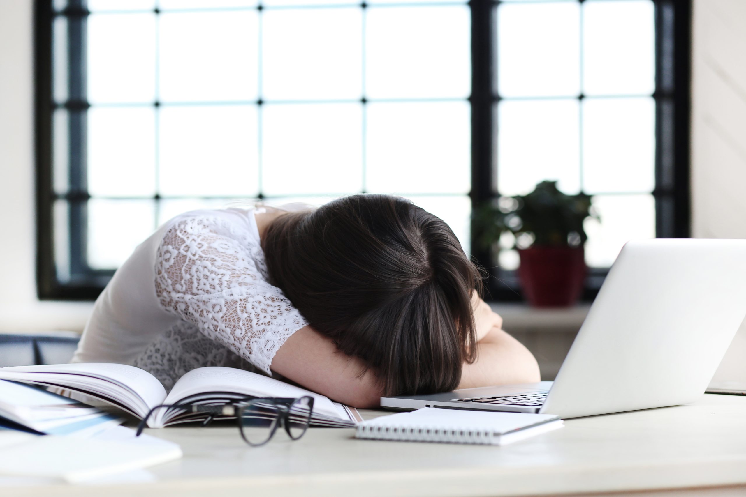 woman hunched over her comptuer