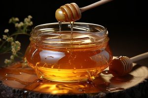 jar of fresh honey with a honey dipping tool.
