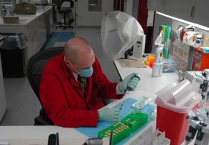 Photo depicts a scientist working in the lab.