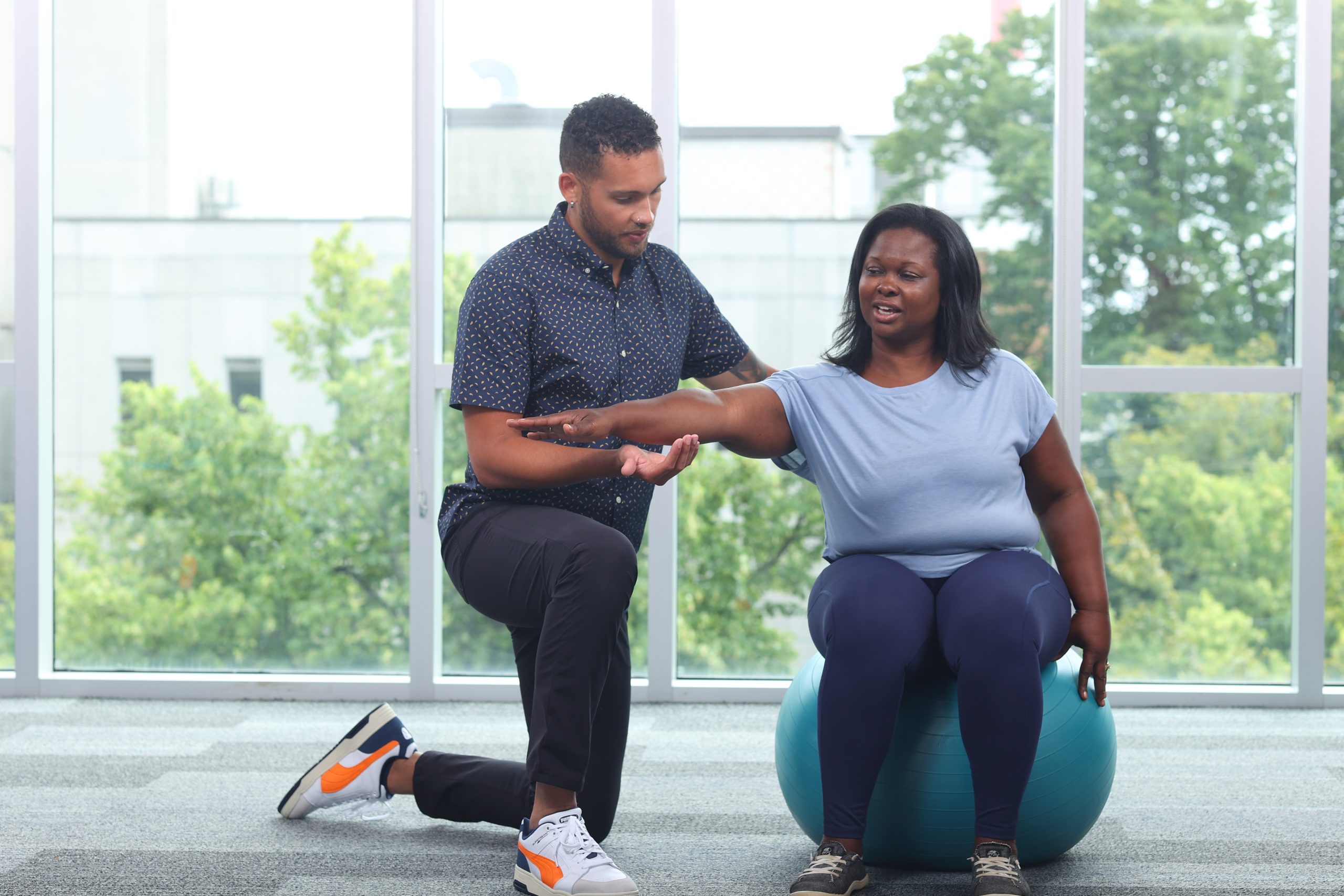 Seated balance on theraball - lateral single arm reach