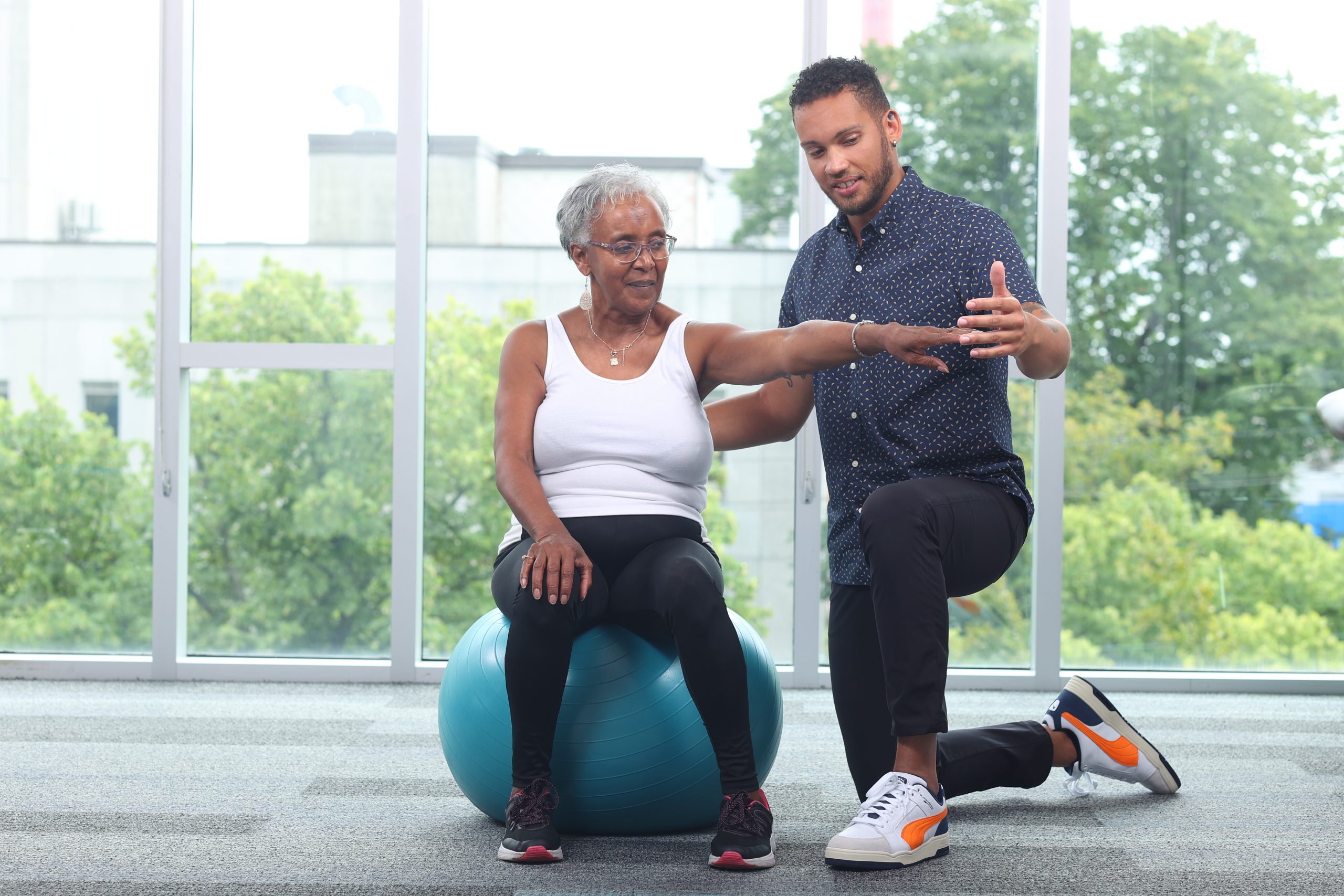 Seated balance on theraball - lateral single arm reach (3)
