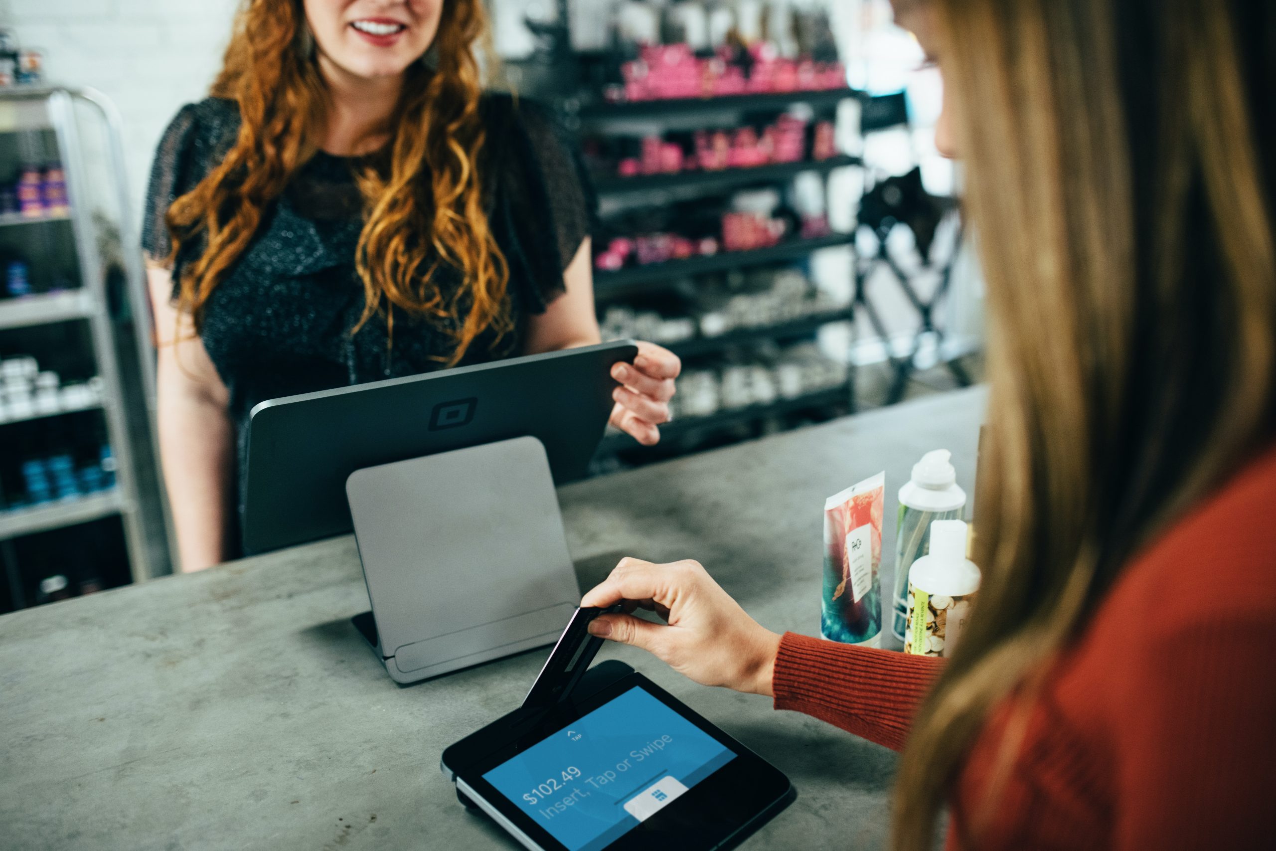 A woman making a purchase at the check-out for a store
