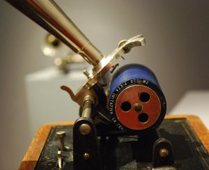 Picture of a phonograph with a blue wax cylinder.