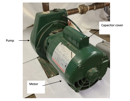 A CSIR motor and pump package. It has a motor on one side, the pump on the other, and the capacitor cover on top of the motor.