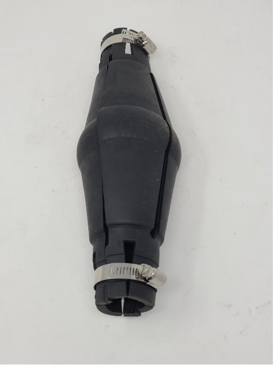 The torque arrestor is black and open on both ends. The two ends are narrower while the middle is wider.
