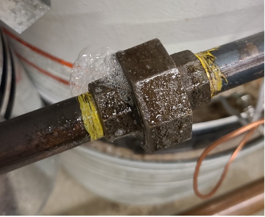 A leaking joint. The leak can be seen from the bubbling around the joint.