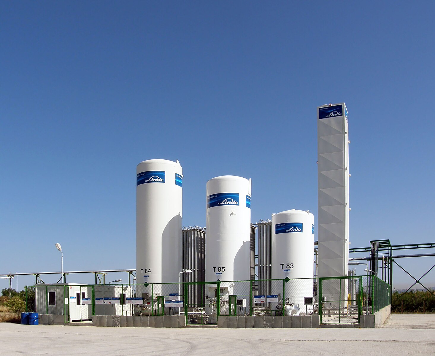 A bulk oxygen storage system with three large white tanks.
