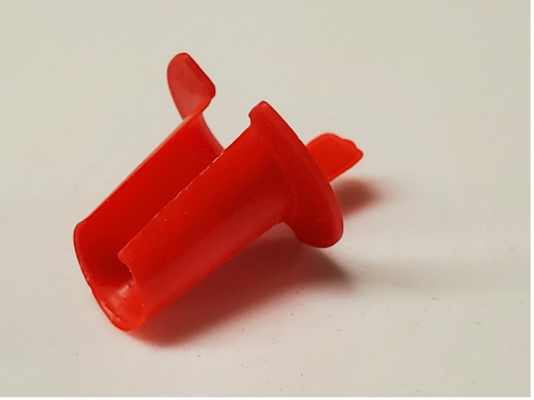 A red tube-like container made of plastic. It is narrower on one side and has a lengthwise opening so that it is not a fully encased tube.